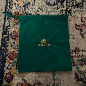 Arbonne // green drawstring bag with golden Arbonne logo